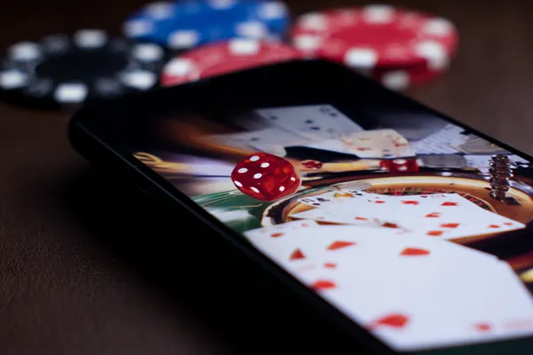 A professional dealer in a tuxedo greeting players at the roulette table, symbolizing the authentic live casino feel at LG111.