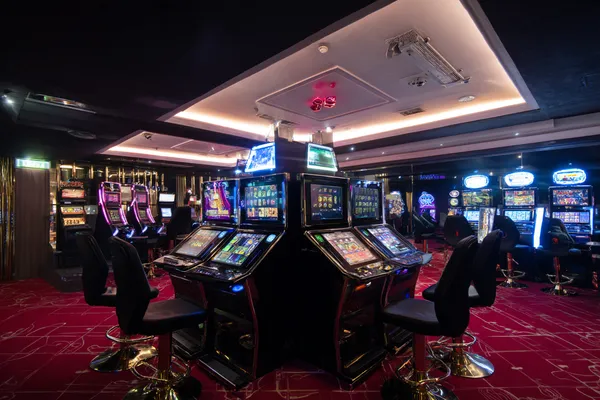 A woman in a luxurious green gown next to an ornate roulette wheel, capturing the upscale casino mood of LG111.